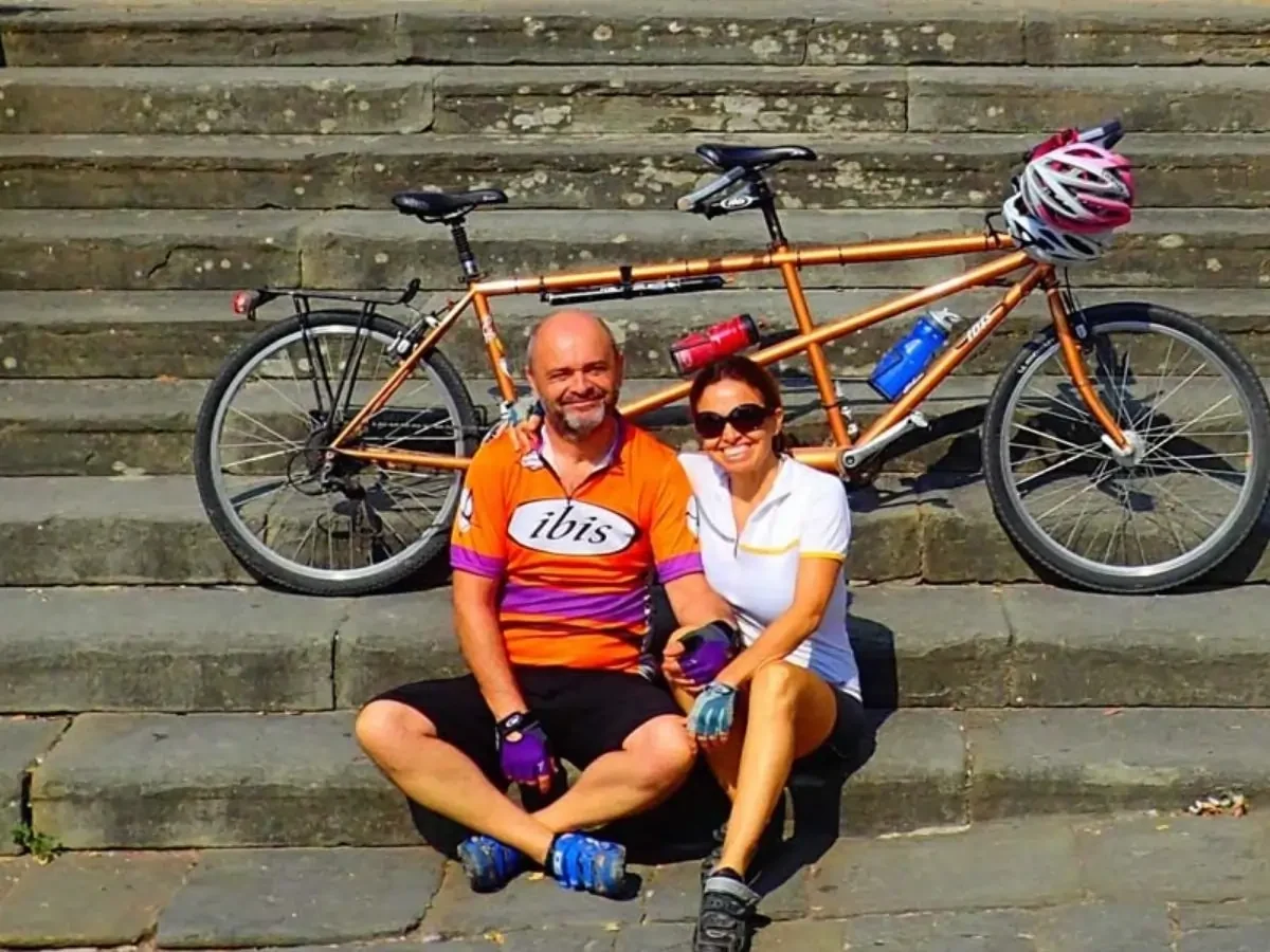 Chicca and Arnaud on stairs resting after riding a tandem bicylce