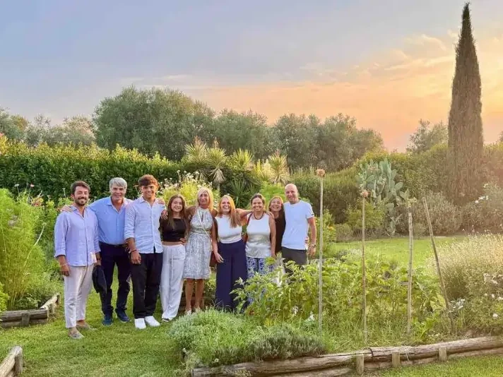 Chicca and guests in front of La Casa Toscana garden with home grown vegetables spices and fruits