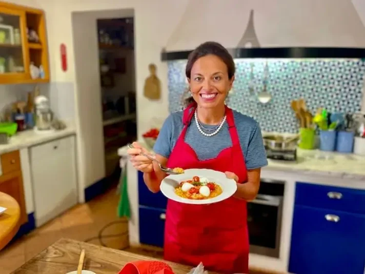 Chicca in kitchen with a fresh cooked Tuscan specialty